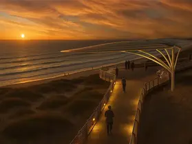 a walkway with people walking on it at sunset