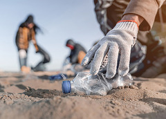People collecting litter on a beach