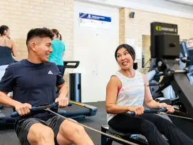 People using rowing machines