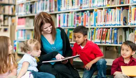 a woman and children in a library