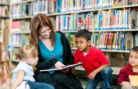 a woman and children in a library