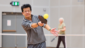 A man playing pickleball
