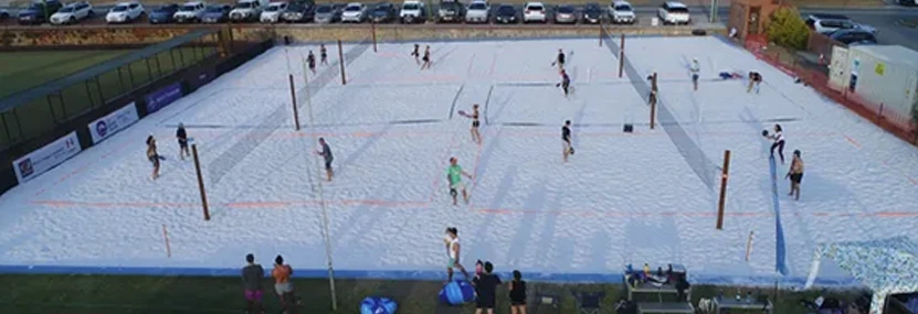 a group of people playing volleyball