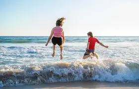 a couple of kids jumping into the water