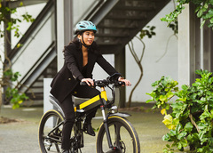 A woman cycling in businesswear