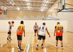 Basketball players practicing shots at the hoop