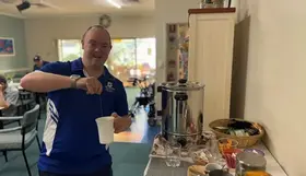 a man pouring a liquid into a cup