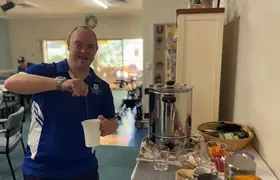 a man pouring a liquid into a cup
