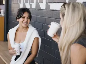 Two women drinking coffee