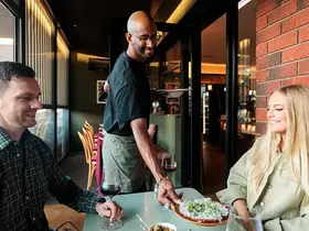 People receiving food at Bar Vino