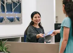 a woman smiling at a woman's hand