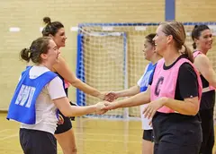 A group of netball players shaking hands