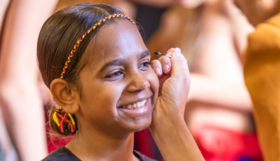 A girl having her face painted