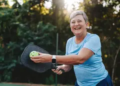 A woman playing pickleball