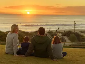 A family watching the sunset on Sunset Hill
