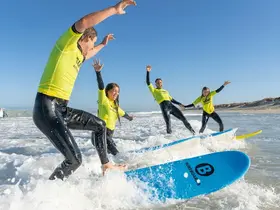 A class taking surfing lessons