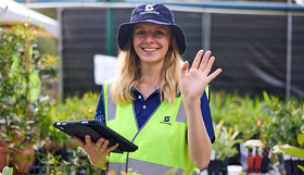 A staff member waving at the camera